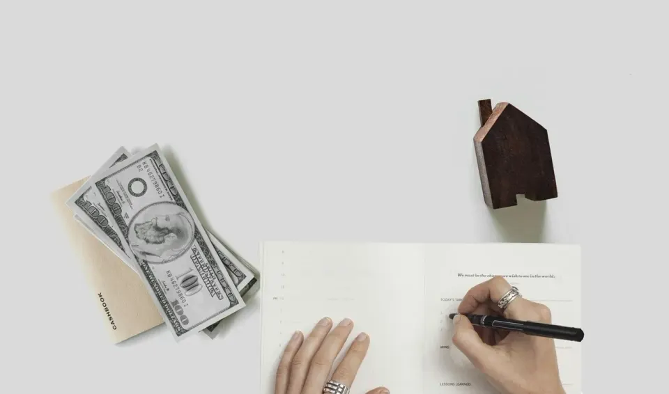 Mortgage paperwork and documents on a desk, where the price and terms get settled